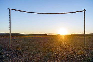 Wooden simple soccer goals on the desert at sunset, Morocco, Africa