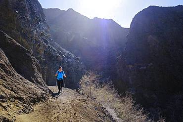 Woman hiking on mountain trail near Taguluche, La Gomera, Canary Islands, Spain, Europe