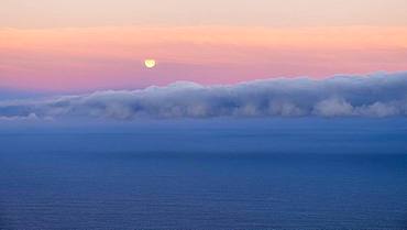 Moonset, sunrise mood at the sea, clouds in the sky, Spain, Europe