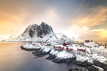 Rorbuer fishermen's cabins by the snowy fjord, Hamnoya, Moskenesoy, Lofoten, Norway, Europe