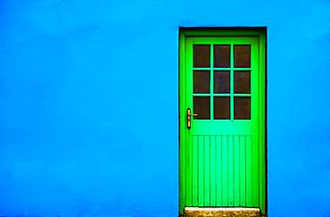 Blue house facade with green front door, Burren, West Coast, County Clare, Republic of Ireland