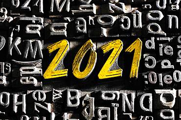 Old lead letters with golden writing show the word 2021, Germany, Europe