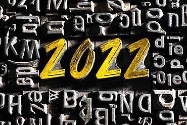 Old lead letters with golden writing show the word 2022, Germany, Europe