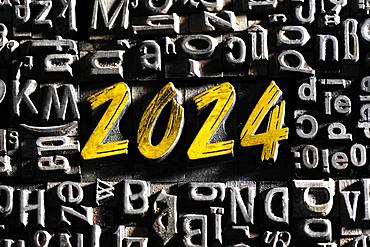 Old lead letters with golden writing show the word 2024, Germany, Europe