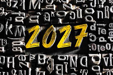 Old lead letters with golden writing show the word 2027, Germany, Europe