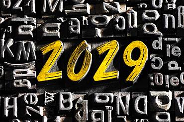 Old lead letters with golden writing show the word 2029, Germany, Europe