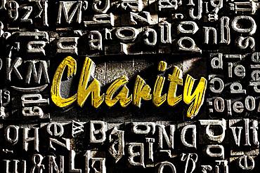 Old lead letters with golden writing show the word Charity, Germany, Europe