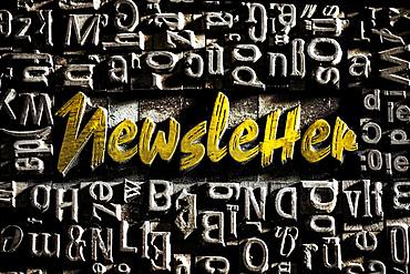 Old lead letters with golden writing show the word Newsletter, Germany, Europe