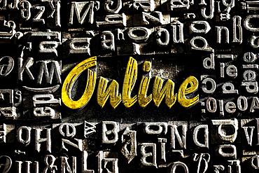 Old lead letters with golden writing show the word Online, Germany, Europe