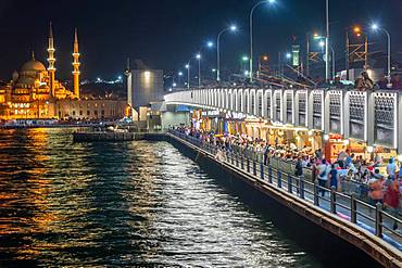 The new mosque and the Galata Bridge in Eminoenue district at night, Istanbul, Turkey, Asia