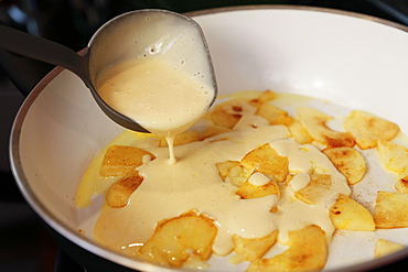 Swabian dessert, preparation apple scratch in a pan, dough with apple pieces and cinnamon, Germany, Europe