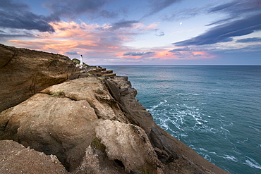 Lighthouse on the cliffs at Castlepoint, in the back turquoise ocean, Masterton, Wellington, New Zealand, Oceania