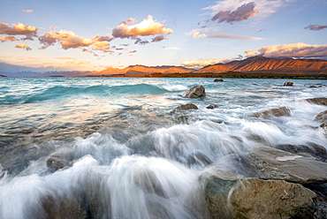 Stones on shore, lake with sunset swell, long time exposure, Lake Tekapo, Canterbury, South Island, New Zealand, Oceania