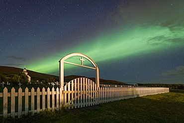 Northern lights over church and cemetery, Hvammstangi, Westfjords, Northwest Iceland, Iceland, Europe