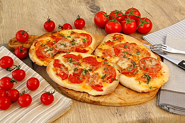 Swabian cuisine, Dinnete, Dennete, Swabian pizza with tomatoes, cheese and basil, served on wooden plates, Germany, Europe