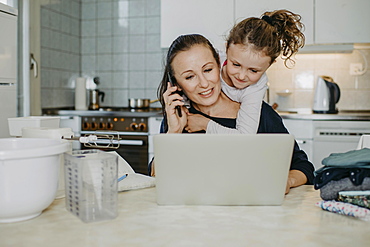 Mother at Home Office, with child and household, Austria, Europe