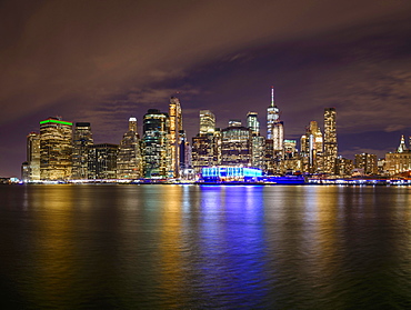 View from Pier 1 at night over the East River to the skyline of lower Manhattan, Dumbo, Downtown Brooklyn, Brooklyn, New York, USA, North America