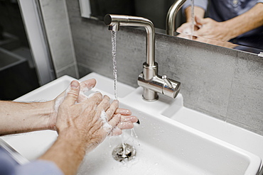 Man washing his hands at the sink