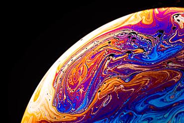 Soap bubble, detail with spectral colors, black background, studio shot, Austria, Europe