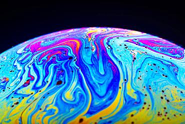 Soap bubble, detail with spectral colors, black background, studio shot, Austria, Europe