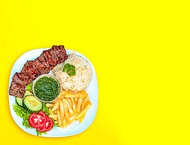 Lunch with cheese, roast beef and french fries, food plate with chalkboard background