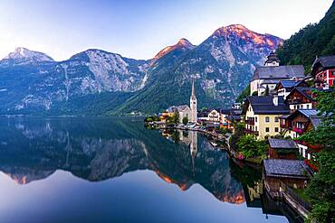 Local view of Hallstatt and the protestant church at sunrise, reflected in the lake Hallstatt, Salzkammergut, Dachstein region, Upper Austria, Austria, Europe