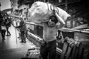 Bang-bang carriers in a market at the port of Chongqing, the carriers are like a caste of their own, carrying loads for the traders for little money, mostly immigrant workers from rural areas, Chongqing, China, Asia