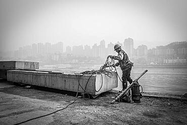 Construction workers on the banks of the Yangtze River, Chongqing Port, Chongqing, China, Asia