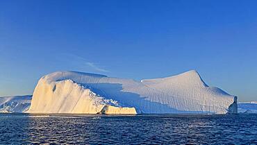 Evening atmosphere with sunlit iceberg, Icefjord, UNESCO World Heritage Site, Disko Bay, West Greenland, Greenland, North America