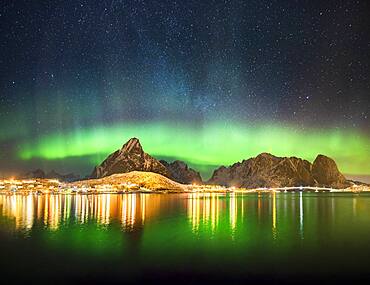 Northern lights at the fjord above the fishing village Reine, Moskenes, Nordland, Lofoten, Norway, Europe