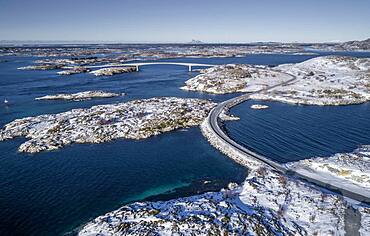 Aerial view, country road through the sea connects populated, small, winterly islands with the mainland, behind mountains, Heroy, Nordland, Norway, Europe