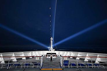 Cruise ship, night, icebergs, searchlights, Atlantic Ocean between Greenland and Iceland