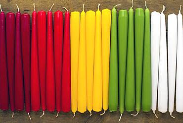 Different colored stick candles next to each other