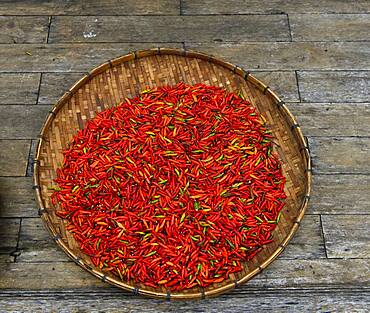 Drying red chillies in a bowl, Luang Prabang, Laos, Asia