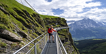 Hiker on a secured hiking trail on the slope, First, Jungfrau Region, Grindelwald, Bern, Switzerland, Europe