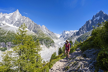 Climber on hiking trail, Grand Balcon Nord, glacier tongue Mer de Glace, behind Grandes Jorasses, Mont Blanc massif, Chamonix, France, Europe