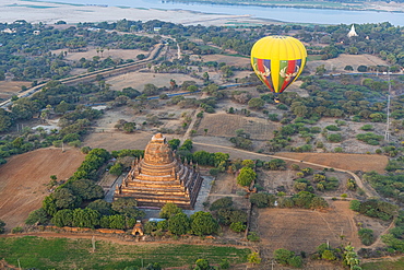 Hot air balloon at sunrise over a temple, Bagan, Myanmar, Asia