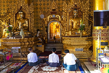 Pilgrims praying in the Shwedagon pagoda, Yangon, Myanmar, Asia