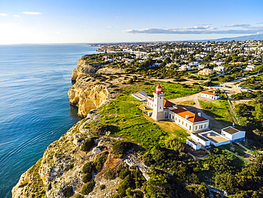 Cliffy coast of Algarve with Alfazinha Lighthouse in Carvoeiro, Portugal, Europe