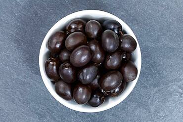 Black olive from above, slate plate, Germany, Europe