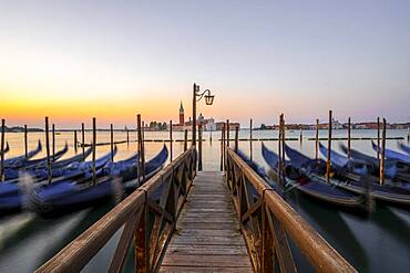 Boat landing stage, jetty with Venetian gondolas, in the back church San Giorgio Maggiore, long exposure, dawn, Venice, Veneto, Italy, Europe