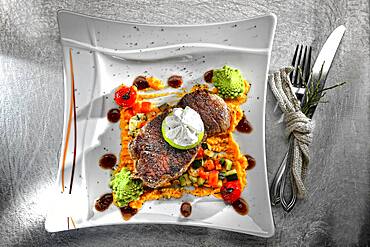 Rump steak, herb butter and vegetables, served on a plate