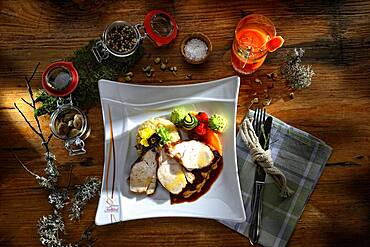 Turkey breast with sauce and risotto, served on a plate