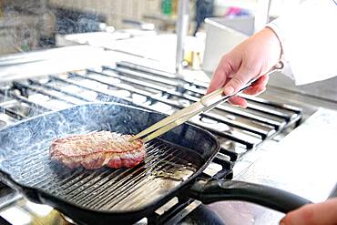 Steak in a grill pan while frying, Germany, Europe