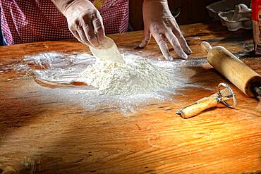 Flour with eggs on wooden table, Germany, Germany, Europe