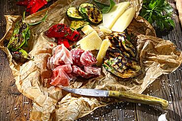 Antipasti with vegetables, cheese, sausage and ham