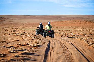 Quadbiker on sand track in the Namib, Namib Rand area, Namibia, Africa