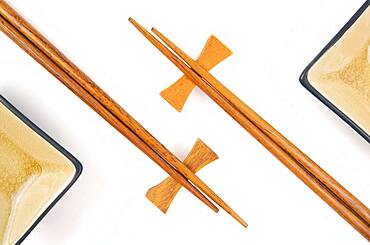 Abstract chopsticks and bowls isolated on a white background