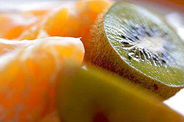 Kiwi and clementine tangerines on a plate in early morning light