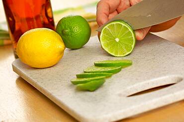 Slicing a lime on a cutting board